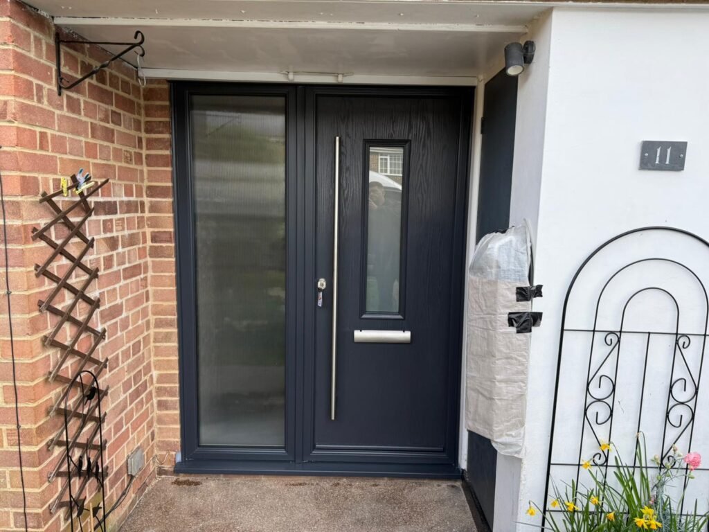 a modern anthracite grey composite door installed in rownhams, Southampton with side panel and long bar handle