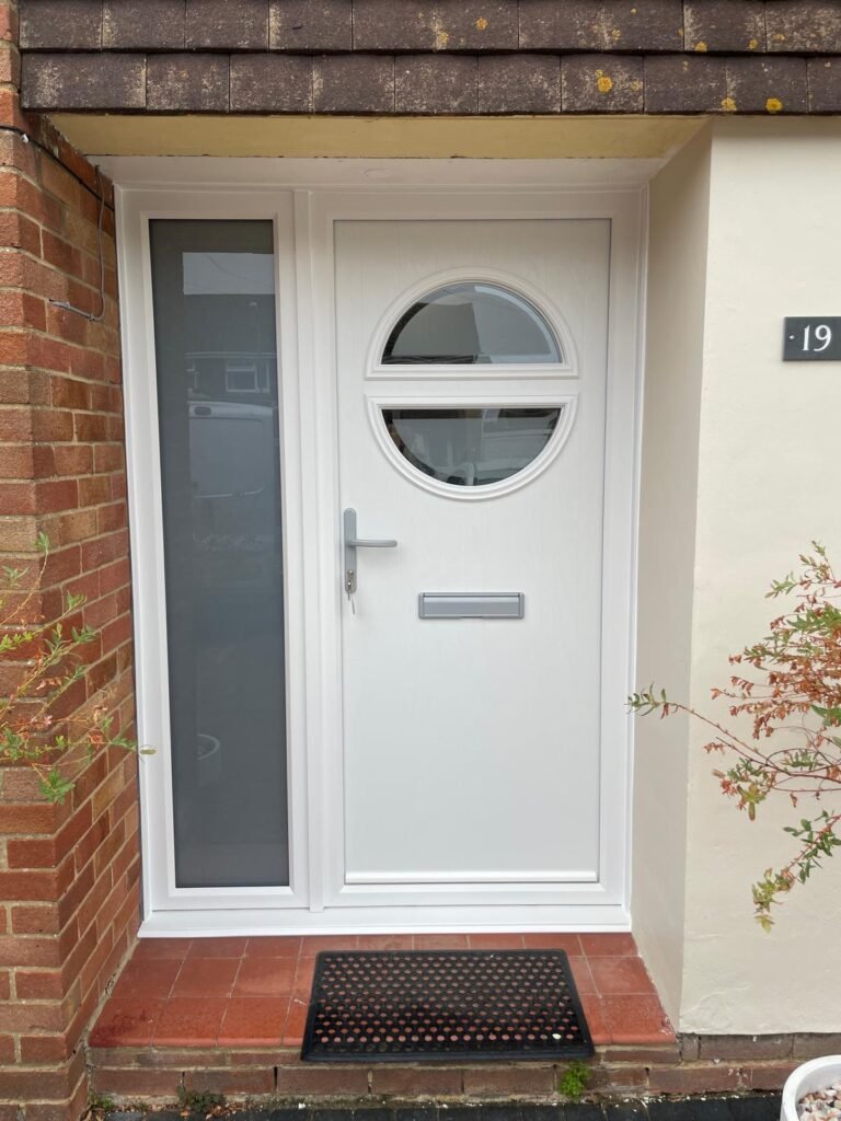 white composite door with chrome hardware and a side panel